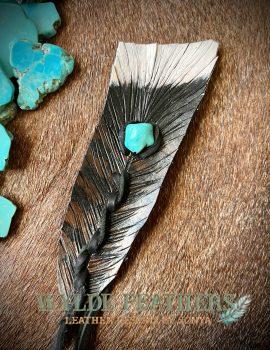 turkey feather with white tip and brown and black colors mixed with a turquoise how lite stone