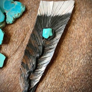 turkey feather with white tip and brown and black colors mixed with a turquoise how lite stone