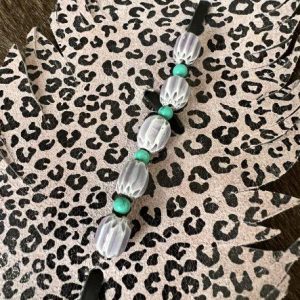 black lilac leopard paired with glass beads and turquoise beads up close