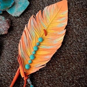 leather feather hat band in orange, lime green and paired with a row of turquoise rivets.