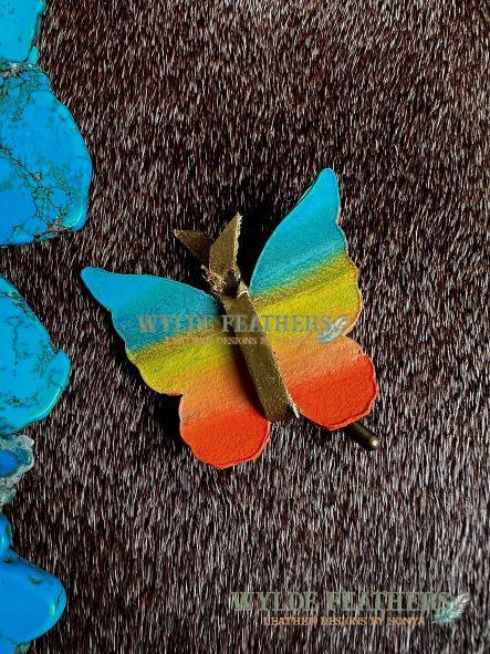 leather butterfly accessory for hat hand painted in turquoise, yellow and orange with back painted light blue