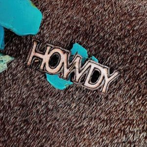 Natural stain howdy pin as an accessory for a cowboy hat
