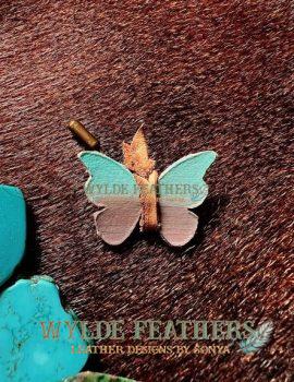 leather butterfly pushpin decorated and hand painted in light blue turquoise, taupe and a natural tan lace.