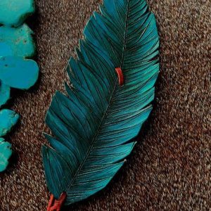Teal green leather feather hat band with a brown stain inot the feather