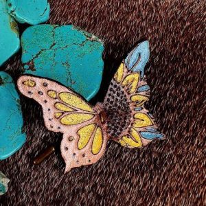 leather butterfly with light blue, yellow and gold sparkles.