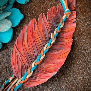 leather feather hat band painted in orange sherbet and hints of brown and teal.
