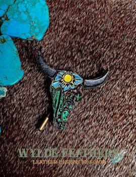 leather longhorn in green, blue, yellow and brown with a raw cowhide on the back.
