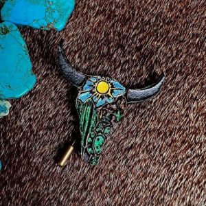 leather longhorn in green, blue, yellow and brown with a raw cowhide on the back.