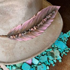 lilac purple leather feather hat band on a taupe-colored cowboy hat