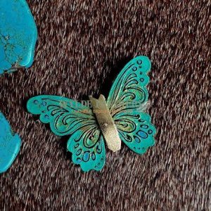 leather butterfly pin that is hand painted turquoise green and gold