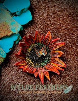 sunflower pin in orange yellow teal and with a center butterfly and a coral orange back. Stick pin antique gold