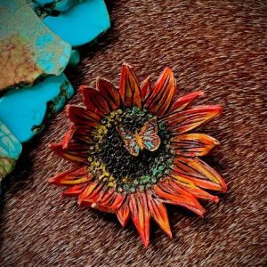 sunflower pin in orange yellow teal and with a center butterfly and a coral orange back. Stick pin antique gold